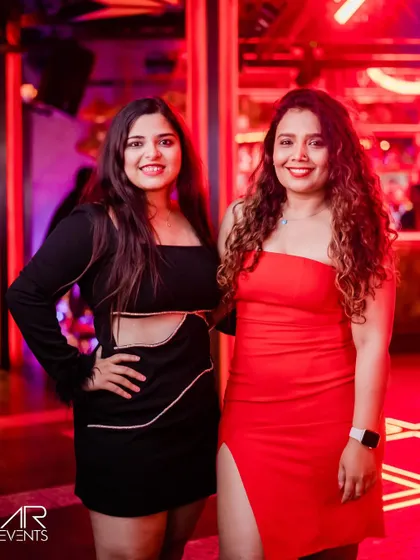 Two friends in classic red and black, enjoying their night out.