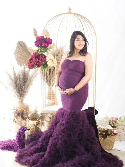 A magical solo portrait in a gorgeous purple mermaid gown. The golden birdcage and floral arrangement in our studio add a touch of fairytale whimsy.