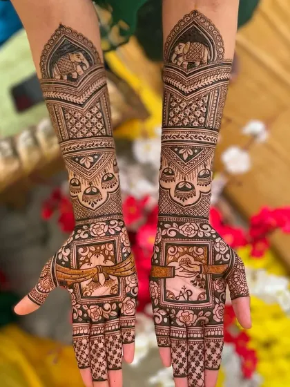 This design features elephant motifs and the couple's initials "AP," surrounded by traditional patterns.