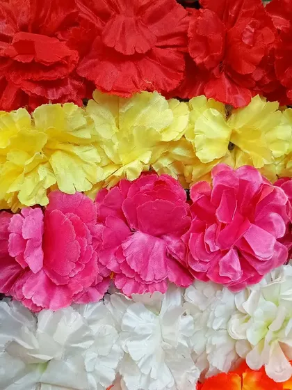 A close up of the high quality artificial flower garlands I stock. These come in vibrant colors like red, yellow, pink, and white, perfect for creating a festive look.
