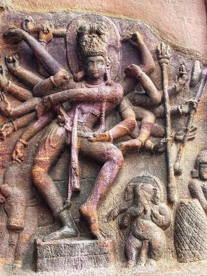 An ancient stone carving of a multi-armed deity in a dynamic dance pose. I draw immense inspiration from these historical depictions of divine movement and power.