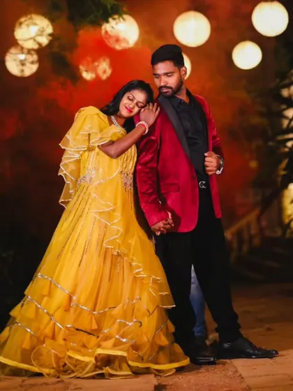 A romantic evening shot with a couple in a yellow tiered gown and a striking red velvet blazer.