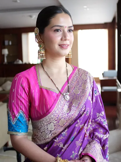 Another angle of this modern-traditional look. The clean makeup allows the vibrant colors of her saree and her beautiful jewelry to take center stage.