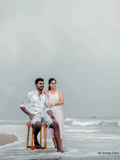 A wider shot from the same beach session, showing the couple enjoying the serene coastal atmosphere.
