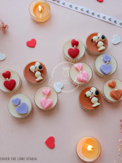 A close-up of the Snoopy and heart tealights. These are perfect for Valentine's Day, anniversaries, or just to show someone you care.