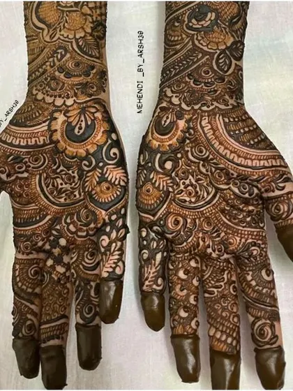 A close-up on the palms, showcasing the dense and detailed patterns that are characteristic of my bridal henna work.