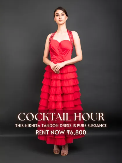 The 'Cocktail Hour' calls for pure elegance, like this red tiered dress by Nikhita Tandon. Its vibrant color and flattering silhouette make it a perfect rental for a glamorous evening party.