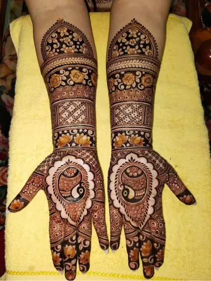 This design features a central paisley motif on the palm, surrounded by delicate floral patterns. The arms have a classic look with bands of flowers and geometric checks.
