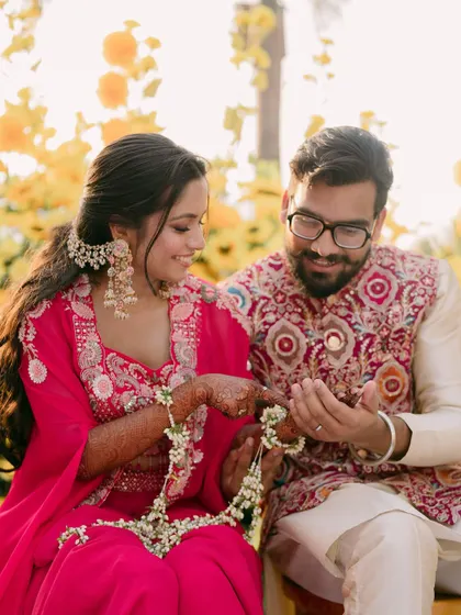 Another lovely shot of the couple with their floral jewelry.