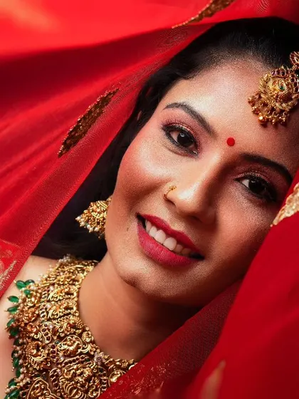 A striking bridal portrait featuring our heavy, intricately designed choker and matching nethi chutti. The antique gold finish is perfect for a traditional wedding look.