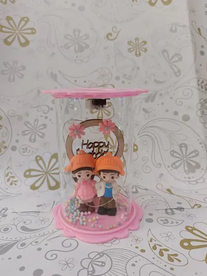 This adorable couple showpiece is encased in a glass dome with LED lights. It's a sweet and romantic gift, perfect for birthdays or anniversaries.