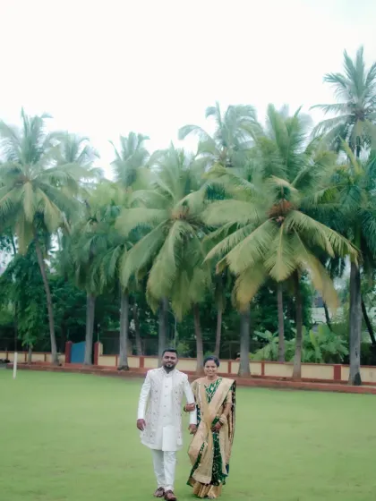 The newly engaged couple walks arm-in-arm towards the camera, their happiness evident in their confident stride.