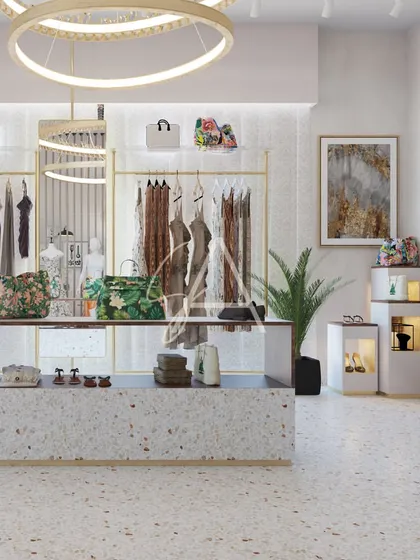 A central display island made of terrazzo with a dark wood top. This serves as a focal point in the retail space, perfect for showcasing new arrivals, handbags, and accessories.