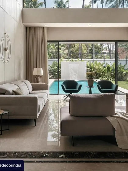 A glimpse into the living room of Villa Shakthi, as featured in Elle Decor. The design connects the interior directly to the poolside, blending modern furniture with a calm, neutral palette to create a sophisticated and relaxing atmosphere.