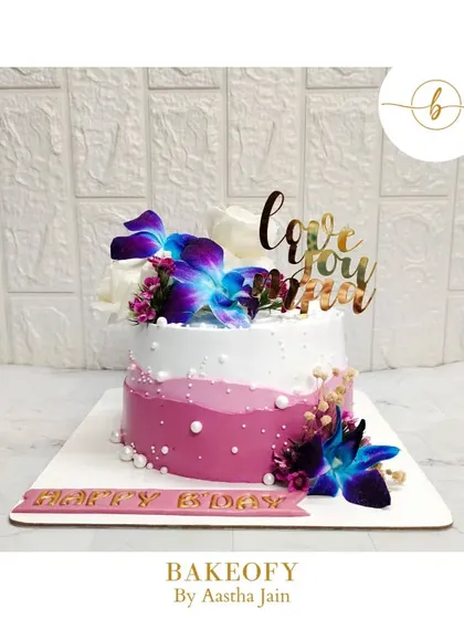 The elegance of lavender dreams. This Nutella cake for a mom's birthday features an ombre design and is topped with beautiful orchids and roses.