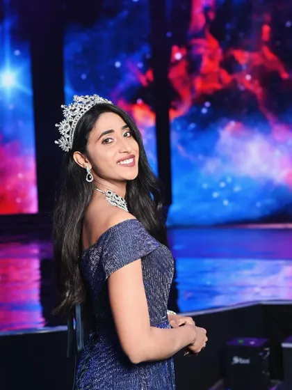 A beautiful portrait of a pageant winner against a starry backdrop. This captures the aspirational and dreamy quality of winning the crown.