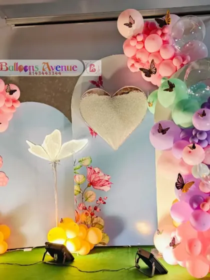 Another detailed shot of the butterfly party decor, highlighting the mix of pastel balloons and butterfly accents.