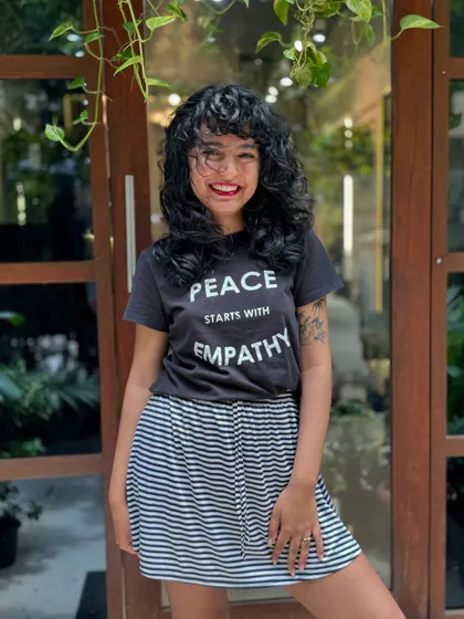Curly bangs are the cutest! This client is radiating joy with her new fringe and layered cut that perfectly frames her smiling face.