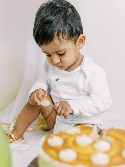 This little one is checking out his first birthday cake, maybe deciding where to start. I love capturing these moments of curiosity during a cake smash session.