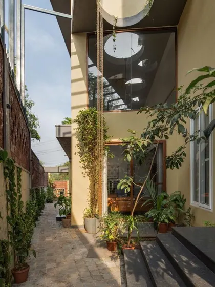 We utilize every part of the site. The setback area is transformed into a green corridor, creating a pocket of nature that provides a soothing view from the interior spaces and helps cool the building.