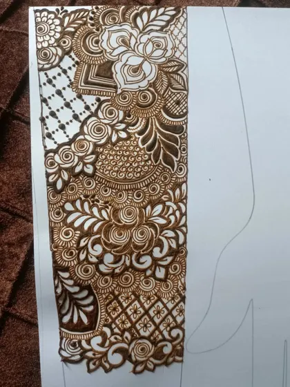 This is a section of a full-arm bridal practice piece. It combines rose motifs, paisley elements, and various grid fillers to create a dense, beautiful pattern.