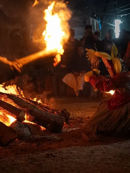 A series capturing the different stages of the Pottan Theyyam ritual, from the performer lying on the embers to being tended to by assistants. These images show the intensity and devotion involved in the all-night ceremony.