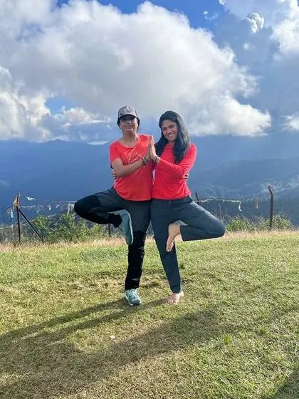 A partner tree pose, demonstrating the support and fun we have on our yoga retreats.