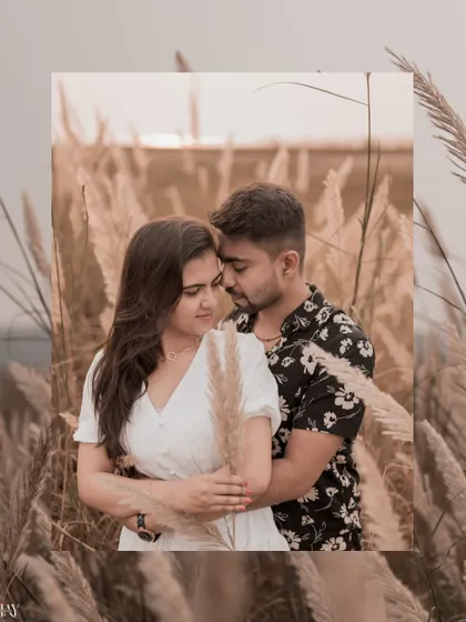 A romantic embrace amidst the pampas grass, with a warm, earthy color tone.