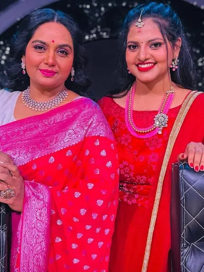 A special moment with a celebrity guest, with my client looking stunning in a red Anarkali.