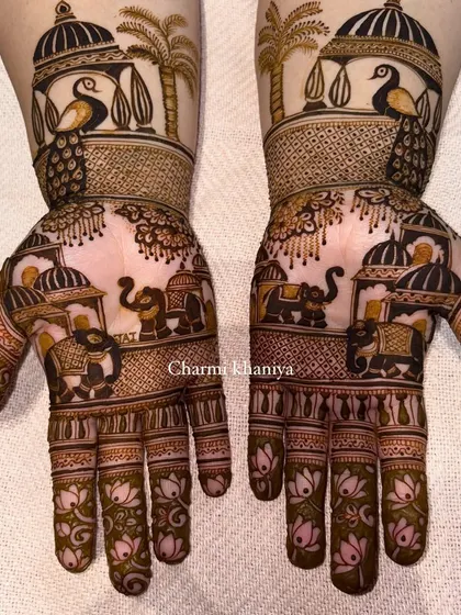 A gorgeous Teej festival mehendi with all the royal elements. This design features proud peacocks perched on palace windows and a family of elephants on the palms, with lotus details on the fingers.
