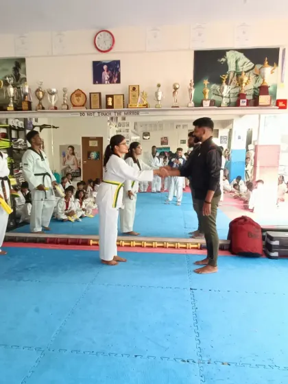 A student receives her new belt.