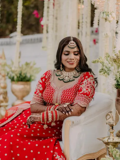 A relaxed and happy bride enjoying her moment. The makeup is flawless, with soft waves in her hair, creating a look that is both elegant and modern.