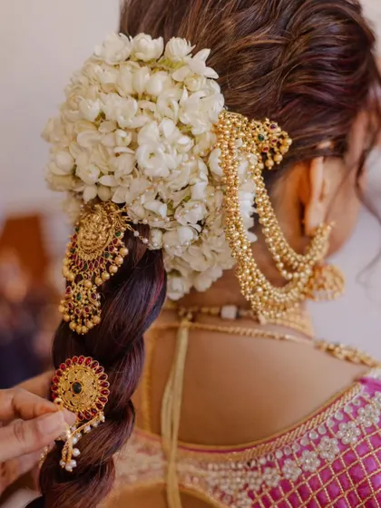 This is the kind of intricate, traditional bridal hairstyle you will master in my class. I focus on teaching the art of creating a beautiful foundation, perfectly placing fresh flowers like this mogra gajra, and securing heavy traditional hair accessories for a look that lasts all day.