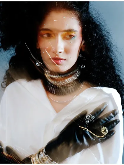 An experimental portrait using long exposure to create light streaks across the model's face. This technique adds a dynamic, energetic layer to an otherwise classic studio portrait.