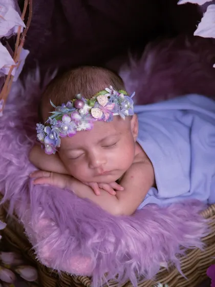 Another angle of our purple floral tent, showing the baby nestled peacefully inside. The soft fur and layers of fabric create a cozy and safe space.