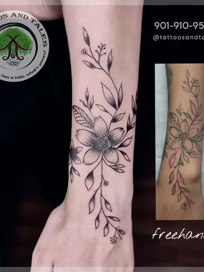 This is how our freehand process works. We sketch the design directly onto your skin, as shown in the smaller image, to create a unique floral piece that perfectly fits your body's contours.