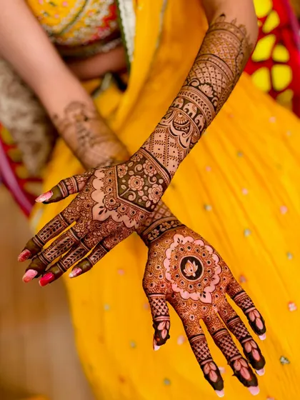This view highlights the lotus mandala on one palm, contrasting with the fuller design on the other arm.