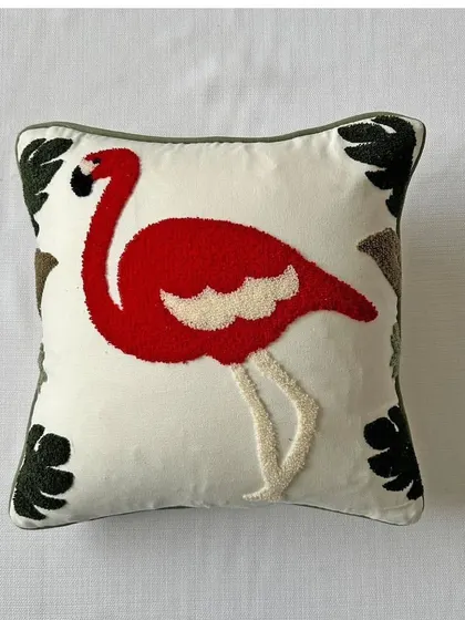 A studio shot of the flamingo cushion cover, allowing you to see the vibrant red and detailed embroidery against a clean white background.