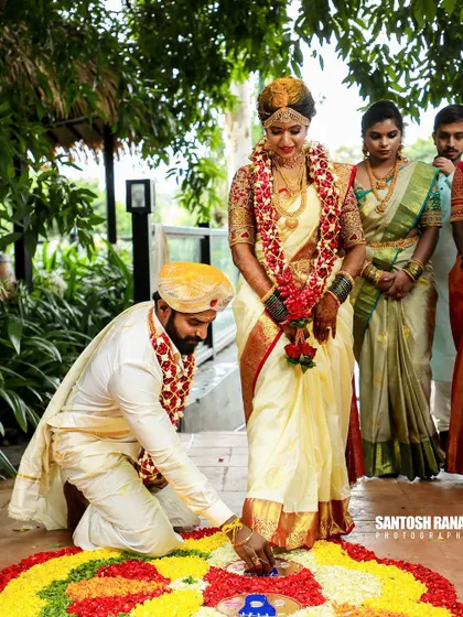 A traditional ritual where the groom places the bride's foot on a floral rangoli, symbolizing their journey together.