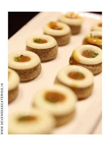 "Bite-Sized Luxury." A close-up of our delicate, ring-shaped canapés, showcasing the precision and artistry of our pastry and garde manger team.
