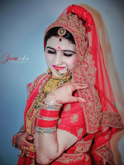 A shy and beautiful portrait of the bride, her pose capturing a classic moment of bridal grace.