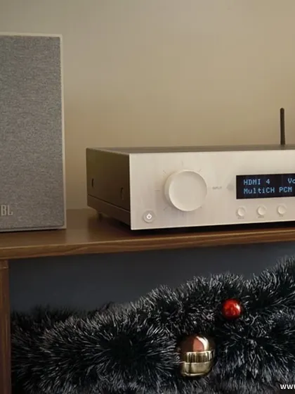 A JBL speaker paired with an amplifier, decorated for the holidays. This setup shows how our systems blend power and style, filling your space with music, joy, and pure holiday magic.