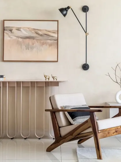 A corner where function meets fashion. This space features a unique console table, a comfortable accent chair, and an adjustable wall lamp, all working in perfect harmony.