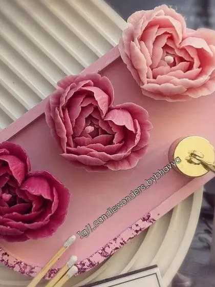 The heart-shaped rose candles displayed on a decorative tray, showing their intricate petal details.