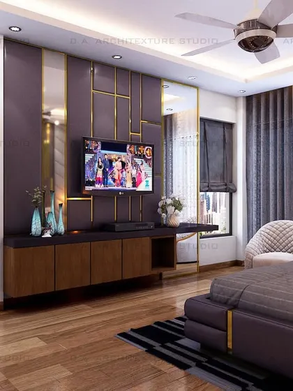 The TV wall opposite the bed, continuing the theme with purple panels and gold accents for a cohesive and glamorous feel.