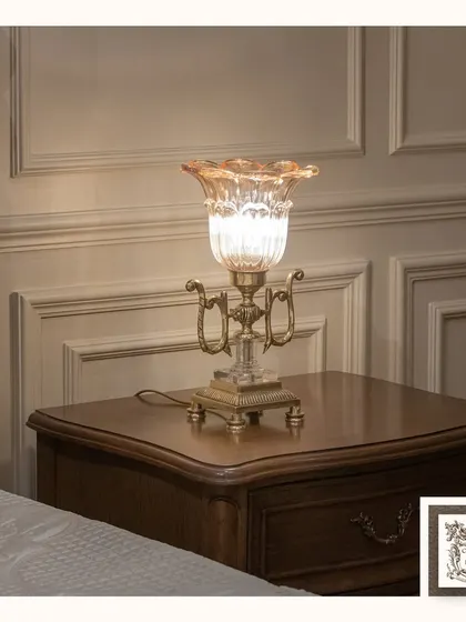 I call this the 'Classic Illuminator'. This table lamp features a beautiful cut-glass body on an ornate brass base, designed to catch and refract light for a dazzling effect.