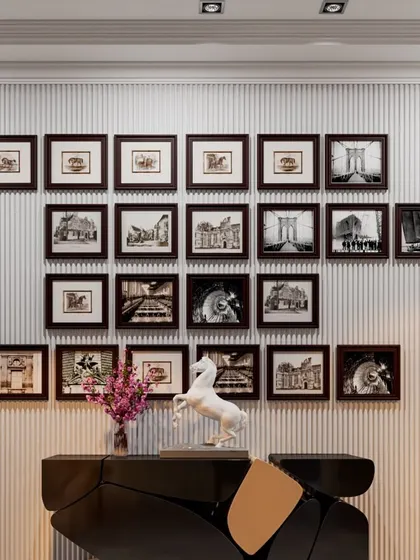 A gallery wall of black and white photographs creates a timeless and personal feature in this apartment. We carefully arrange artwork to create a balanced and visually compelling composition.