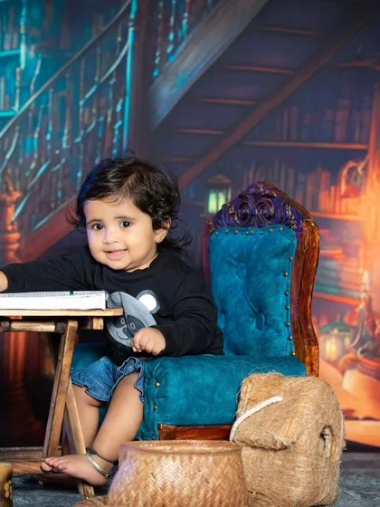 A curious look from a baby in the library setting.
