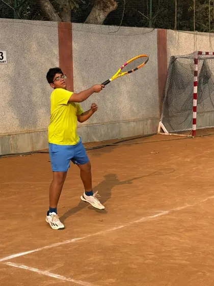 A young player hitting a forehand with intensity. We encourage our players to be aggressive and play with confidence.