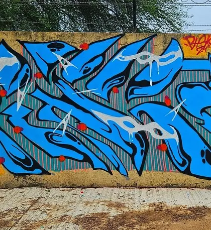 A sharp, blue wildstyle piece with red accents. Each artist brings their own flavor to the wall during a jam.